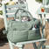 Done By Deer Quilted bag Green hoitolaukku tuolilla. - Hoitolaukut ja organizerit - 7033603 - 4
